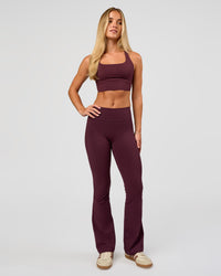 Woman wearing Twist Long Line Sports Bra in Cherry Lacquer | Model:Issy | Size:XS