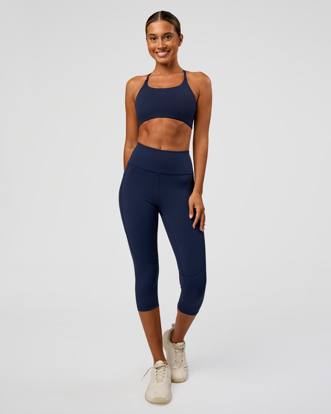 Woman wearing Twist Sports Bra - Future Navy | Model:Charli | Size:XS