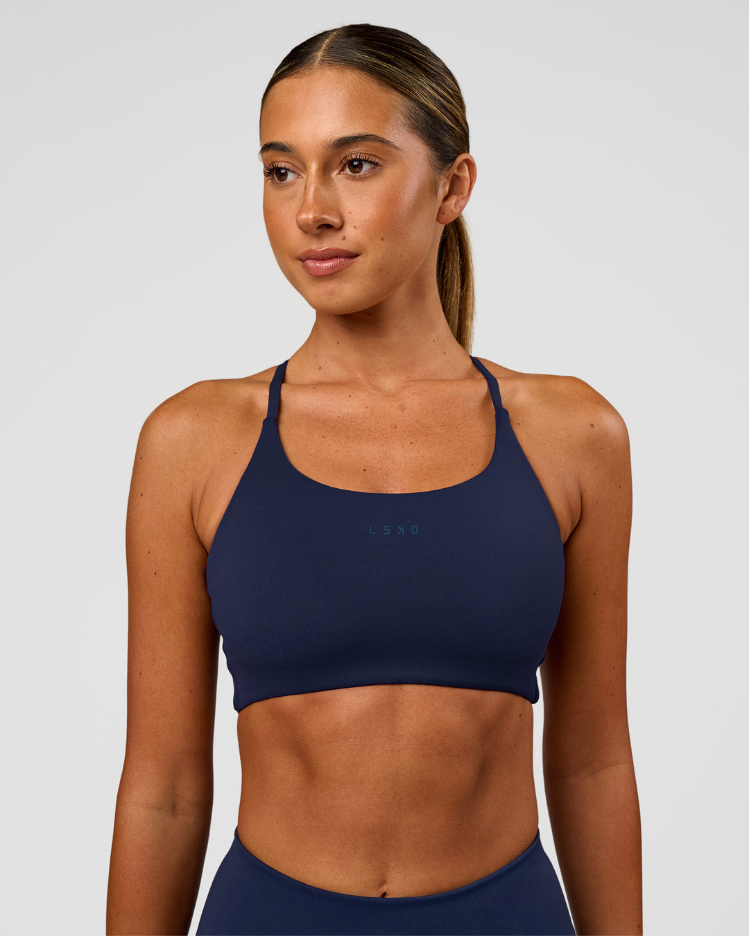 Woman wearing Twist Sports Bra - Future Navy | Model:Charli | Size:XS