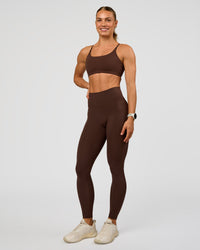 Woman wearing Twist Sports Bra - Hot Chocolate | Model:Maja | Size:XS