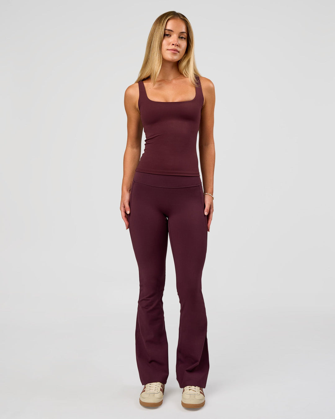 Woman wearing Twist Square Neck Shelf Bra Tank in Cherry Lacquer | Model:Issy | Size:XS