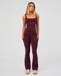 Woman wearing Twist Square Neck Shelf Bra Tank in Cherry Lacquer | Model:Issy | Size:XS