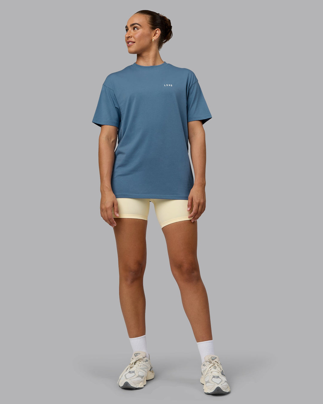 Woman wearing Unisex Move Fast Value Series FLXCotton Tee Oversize - Elemental Blue-Off White