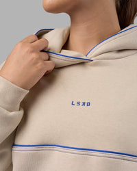 Woman wearing Unisex Oversized Piping Hoodie - Shale Beige-Power Cobalt | Model:Charlize | Size:XS