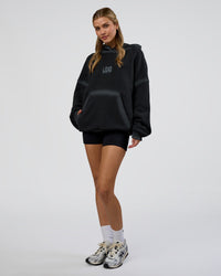Woman wearing Urban Blur Unisex Oversized Hoodie - Black-Dark Storm | Model:Leilani | Size:XS