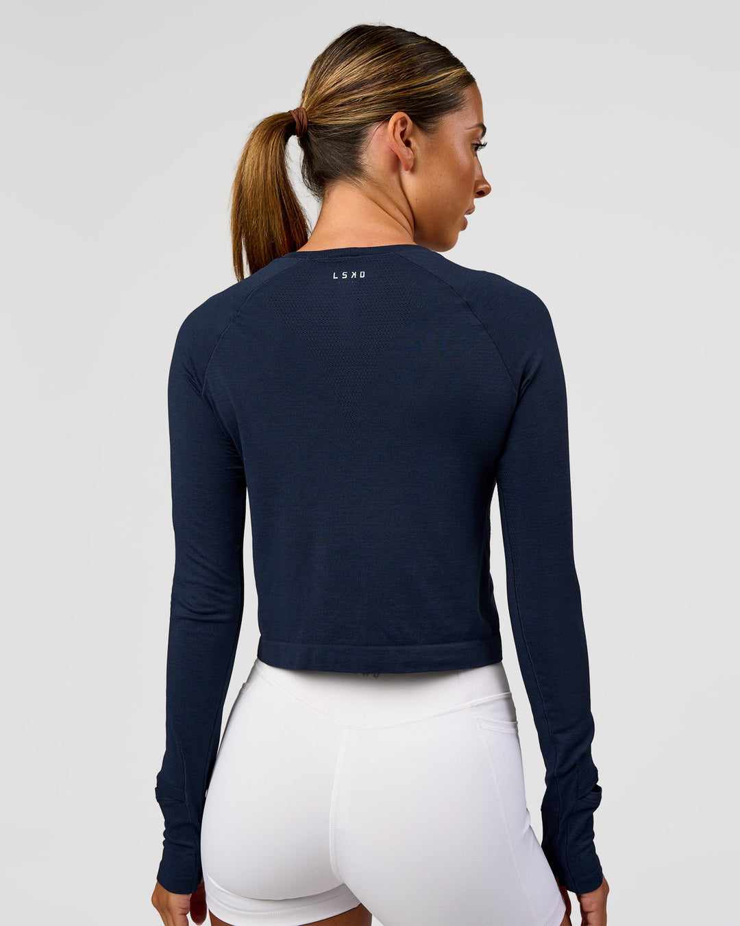 Woman wearing AeroFLX+ Seamless Long Sleeve Skimmer Tee - Future Navy/Future Navy | Model:Charli | Size:XS