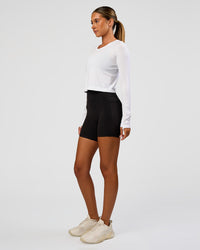 Woman wearing AeroFLX+ Seamless Long Sleeve Skimmer Tee - White/White | Model:Charli | Size:XS