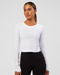 Woman wearing AeroFLX+ Seamless Long Sleeve Skimmer Tee - White/White | Model:Charli | Size:XS | Thumbnail Index: 3