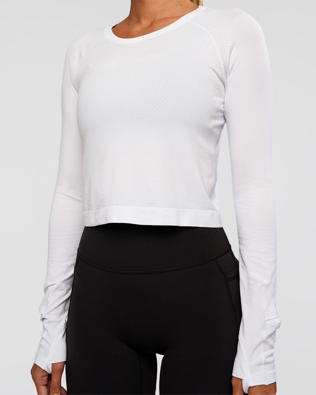 Woman wearing AeroFLX+ Seamless Long Sleeve Skimmer Tee - White/White | Model:Charli | Size:XS