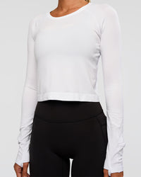 Woman wearing AeroFLX+ Seamless Long Sleeve Skimmer Tee - White/White | Model:Charli | Size:XS