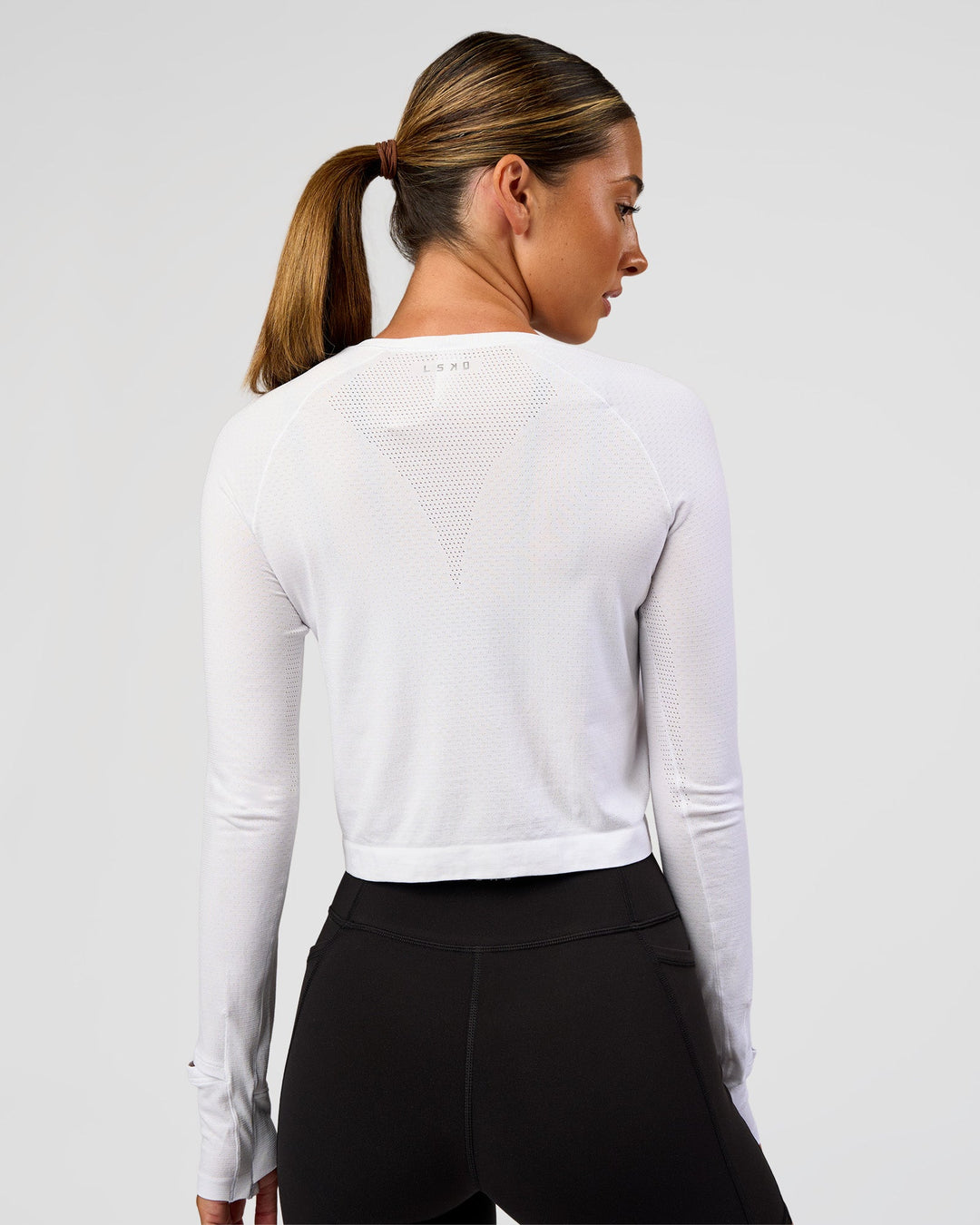Woman wearing AeroFLX+ Seamless Long Sleeve Skimmer Tee - White/White | Model:Charli | Size:XS - view 7