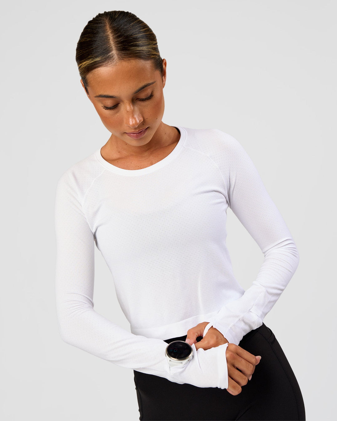 Woman wearing AeroFLX+ Seamless Long Sleeve Skimmer Tee - White/White | Model:Charli | Size:XS - view 1