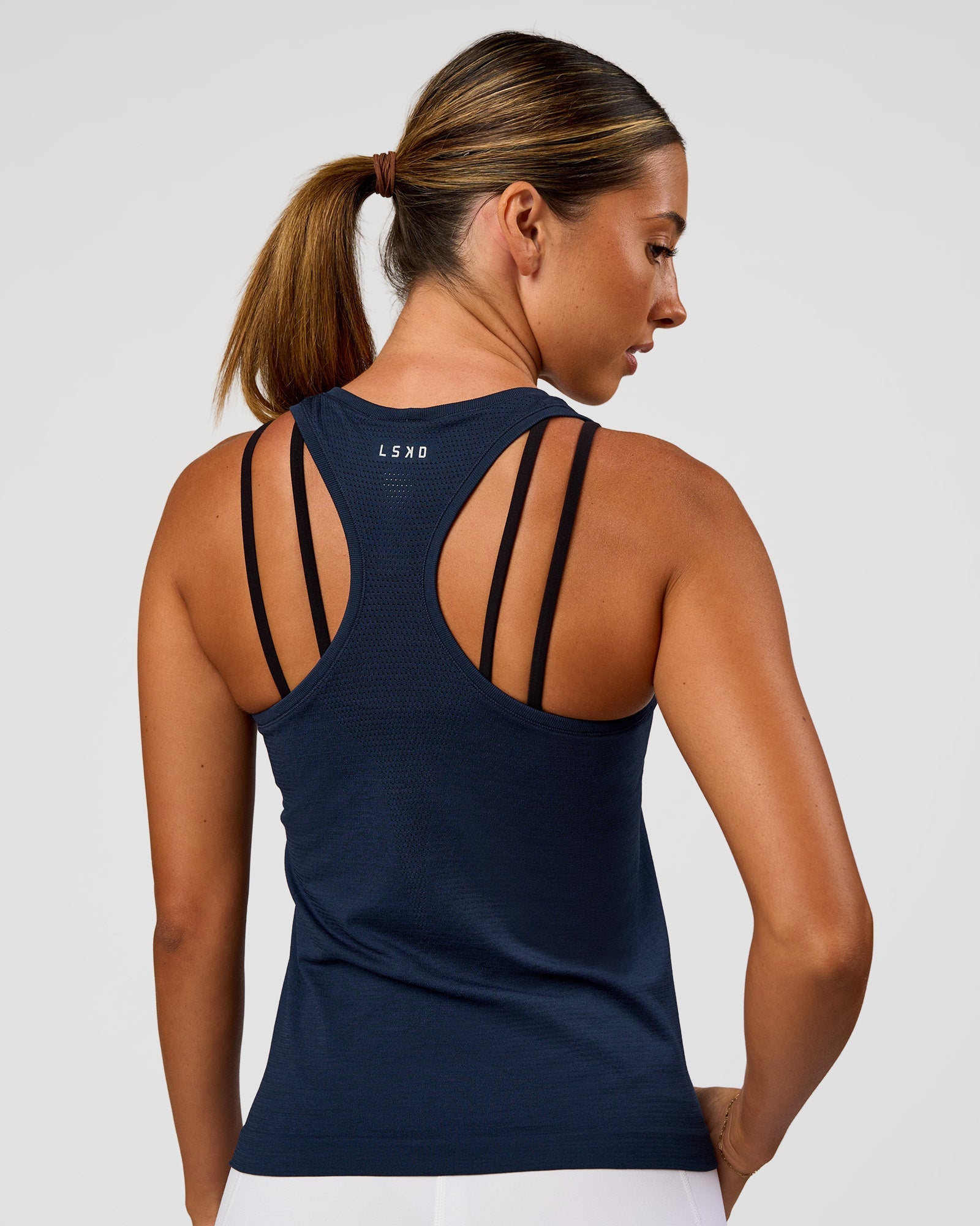 Woman wearing AeroFLX+ Seamless Tank - Future Navy/Future Navy | Model:Charli | Size:XS