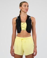 Woman wearing Pace Running Vest - Black-Reflective | Model:Evie | Size:XS/S