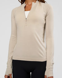 Woman wearing AeroFLX+ Long Sleeve Half Zip - Shale Beige/Shale Beige | Model:Dakota | Size:XS