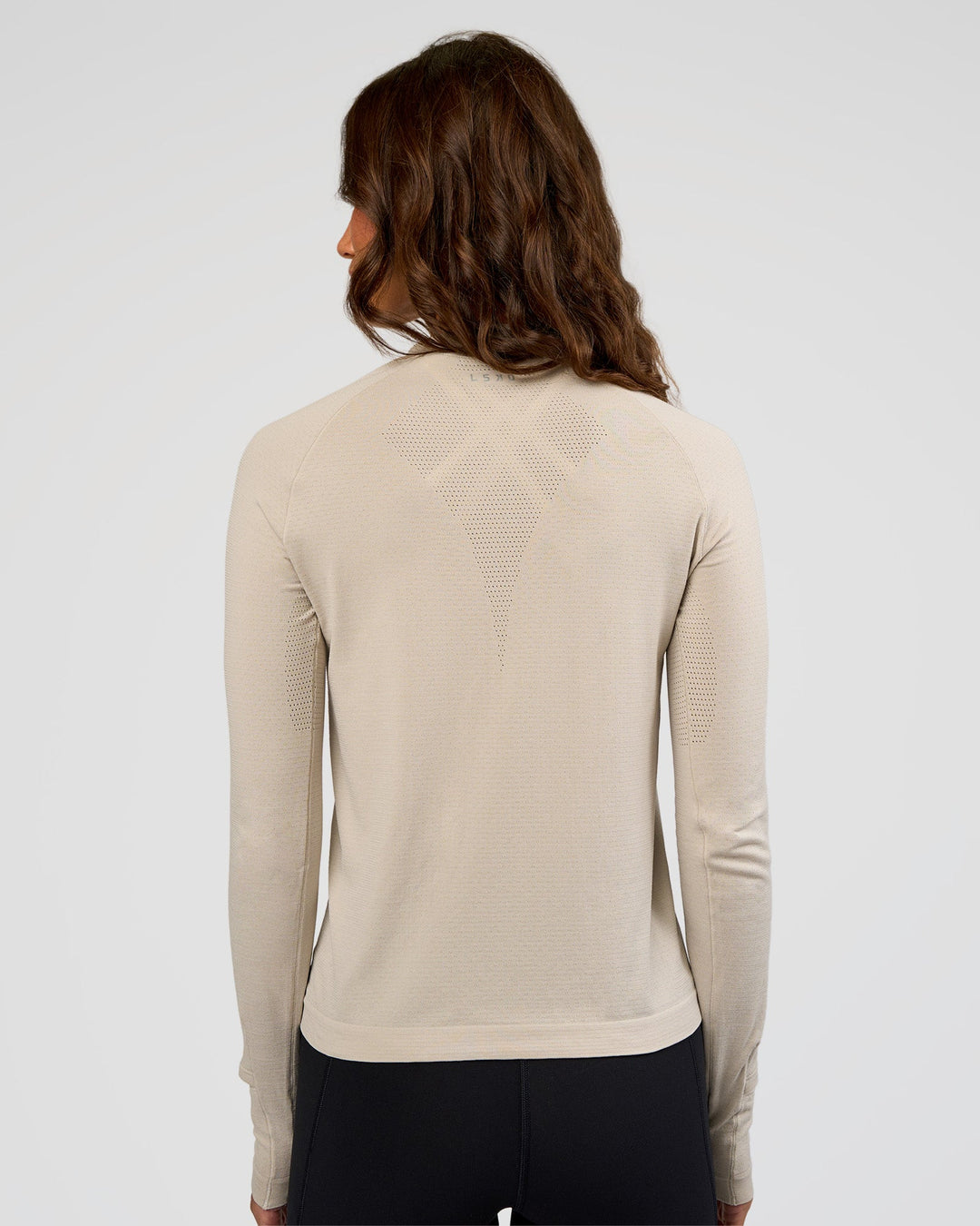 Woman wearing AeroFLX+ Long Sleeve Half Zip - Shale Beige/Shale Beige | Model:Dakota | Size:XS
