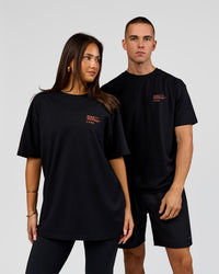 Duo wearing Coffee Run FLXCotton Oversized Tee - Black-Ultra Orange | Model:Albert | Size:M | Model:Bianca | Size:XS | Thumbnail Index: 3