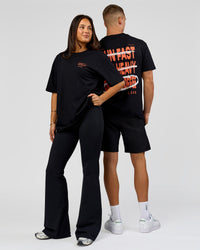 Duo wearing Coffee Run FLXCotton Oversized Tee - Black-Ultra Orange | Model:Albert | Size:M | Model:Bianca | Size:XS | Thumbnail Index: 2
