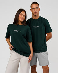 Duo wearing VS1 Enjoy The Journey FLXCotton Oversize Tee - Midnight Green | Model:Albert | Size:M | Model:Bianca | Size:XS | Thumbnail Index: 0