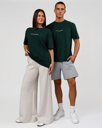 Duo wearing VS1 Enjoy The Journey FLXCotton Oversize Tee - Midnight Green | Model:Albert | Size:M | Model:Bianca | Size:XS | Thumbnail Index: 3