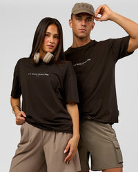 Duo wearing VS6 1% Better FLXCotton Oversize Tee - Ground Coffee | Model:Albert | Size:M | Model:Bianca | Size:XS | Thumbnail Index: 0