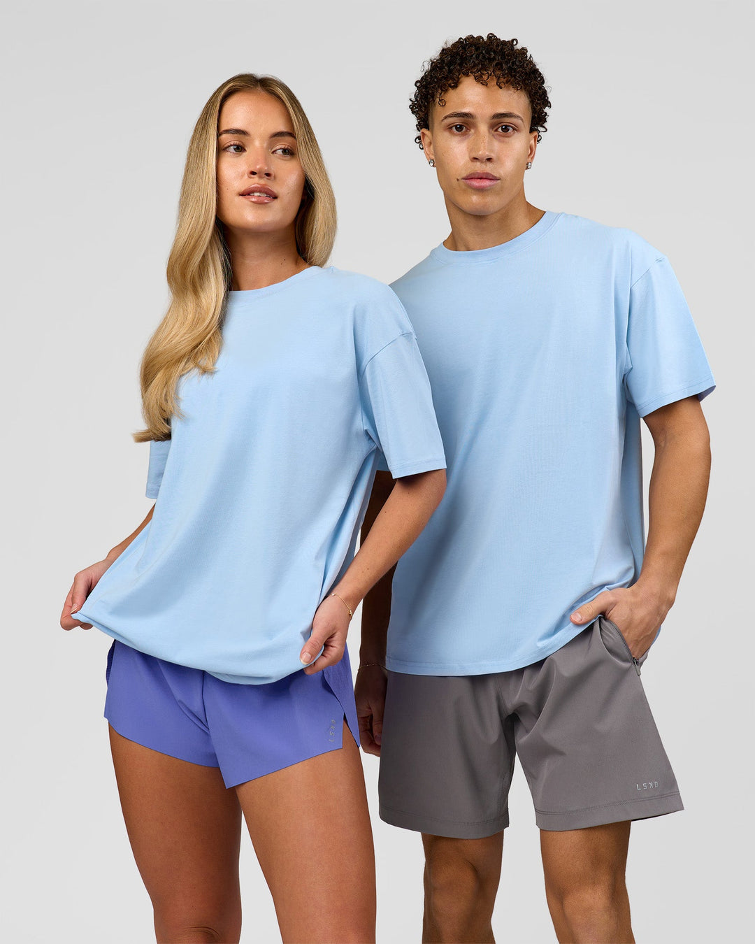 Duo wearing Benchmark FLXCotton Oversized Tee - Open Air-Blue Bell | Model:Leandro | Size:M | Model:Issy | Size:XS