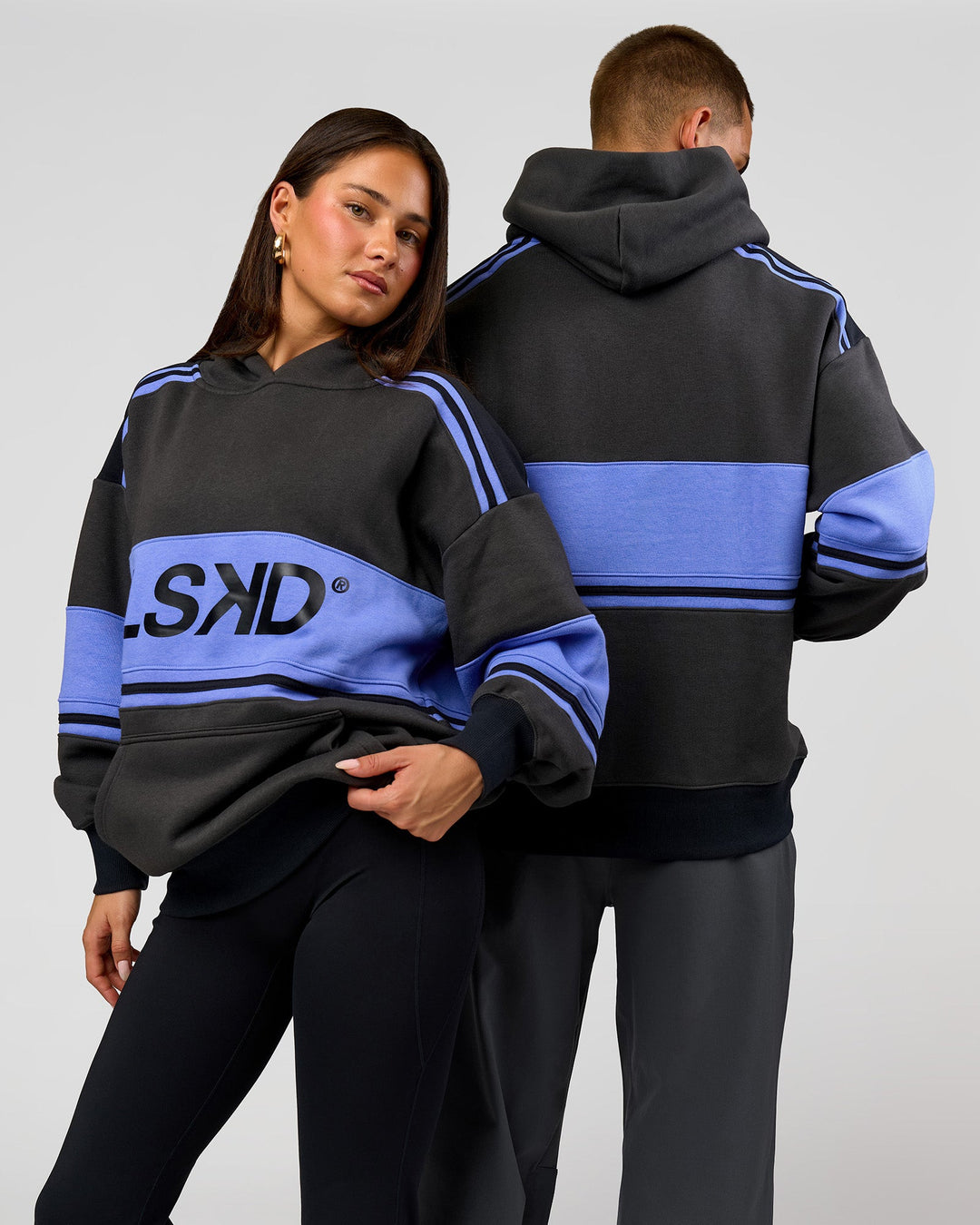 Duo wearing A-Team Oversized Hoodie - Onyx-Bluebell | Model:Bianca | Size:XS | Model:Albert | Size:M - view 1