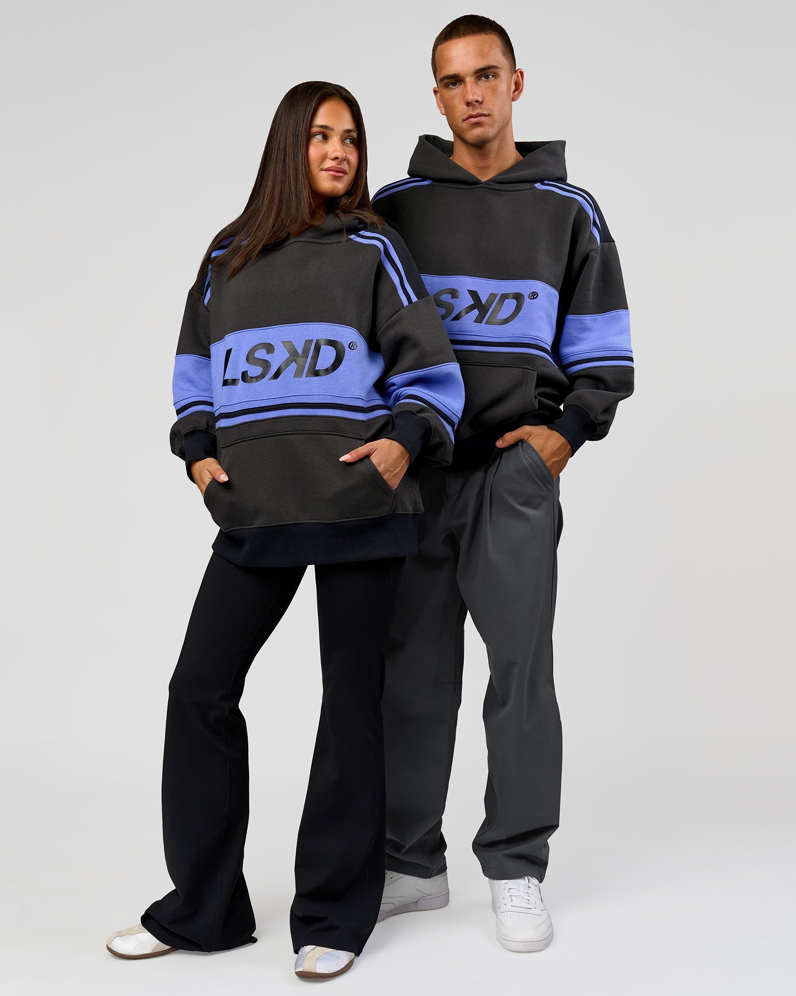 Duo wearing A-Team Oversized Hoodie - Onyx-Bluebell | Model:Bianca | Size:XS | Model:Albert | Size:M