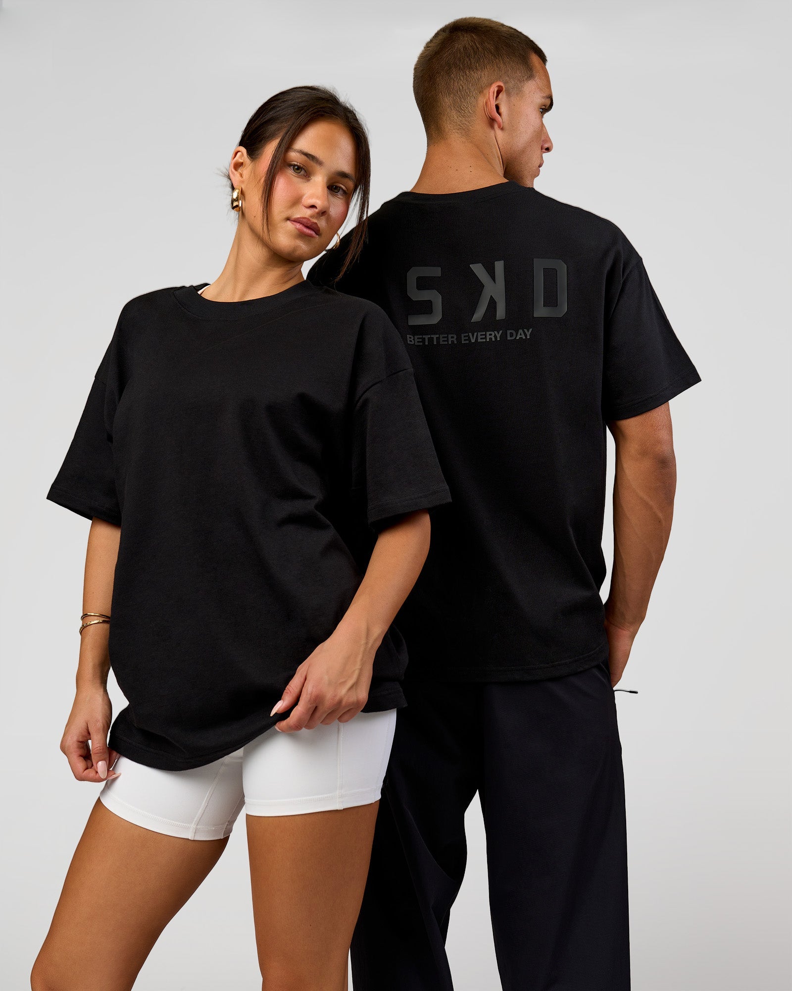 Duo wearing Tonal Legacy Heavyweight Oversized Tee - Black-Black | Model:Bianca | Size:XS | Model:Albert | Size:M
