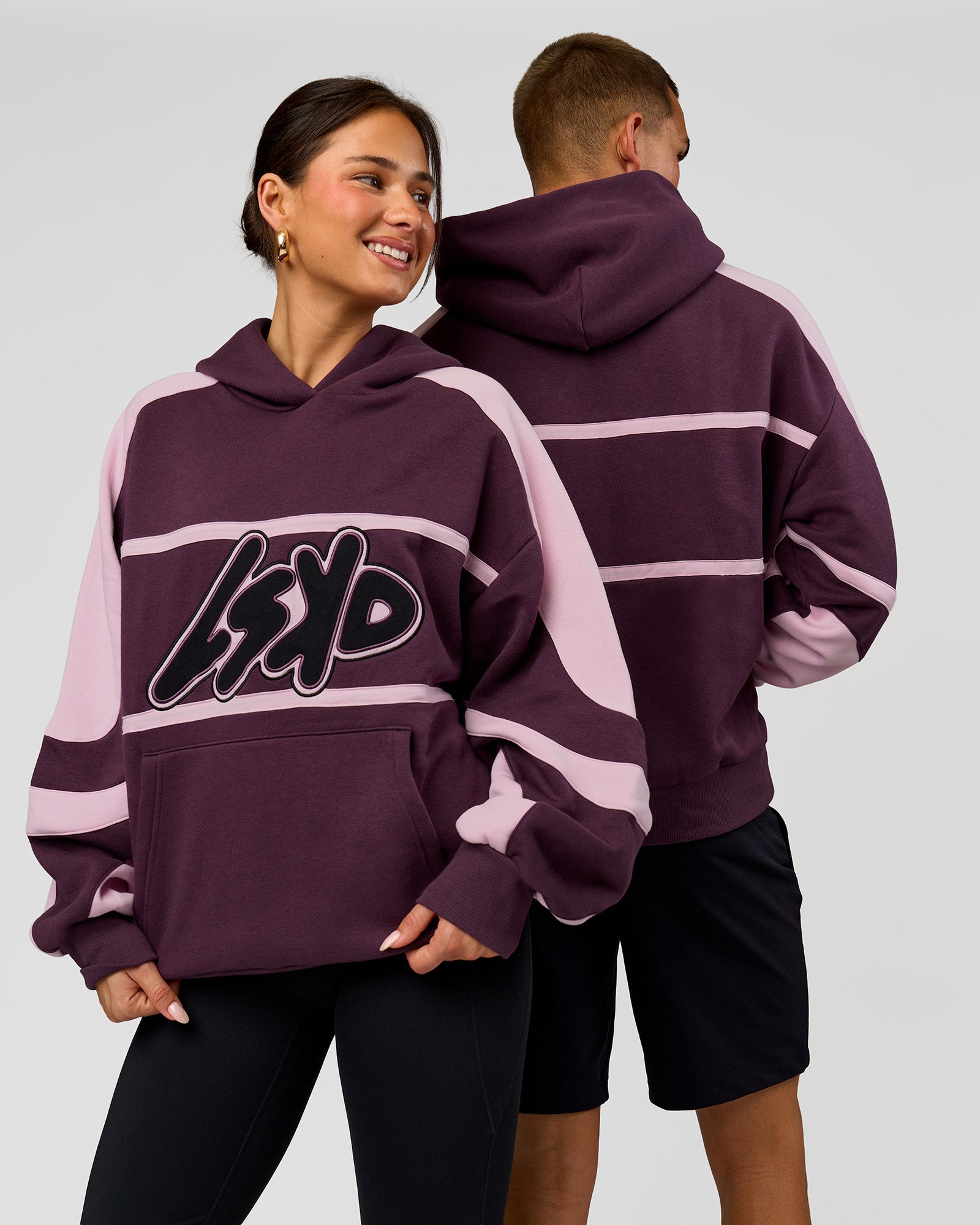 Duo wearing Vibe Oversized Hoodie - Midnight Plum-Marshmallow | Model:Bianca | Size:XS | Model:Albert | Size:M