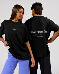 Duo wearing VS26 1% Better FLXCotton Oversize Tee - Black-White | Model:Charli | Size:XS | Model:George | Size:M | Thumbnail Index: 0