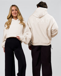 Duo wearing Tonal Legacy Boxy Hoodie - Off White-Off White | Model:Issy | Size:XS | Model:Xav | Size:L | Thumbnail Index: 0