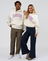Duo wearing Varsity Boxy Hoodie - Off White-Pink Rose | Model:Issy | Size:XS | Model:Xav | Size:L | Thumbnail Index: 2