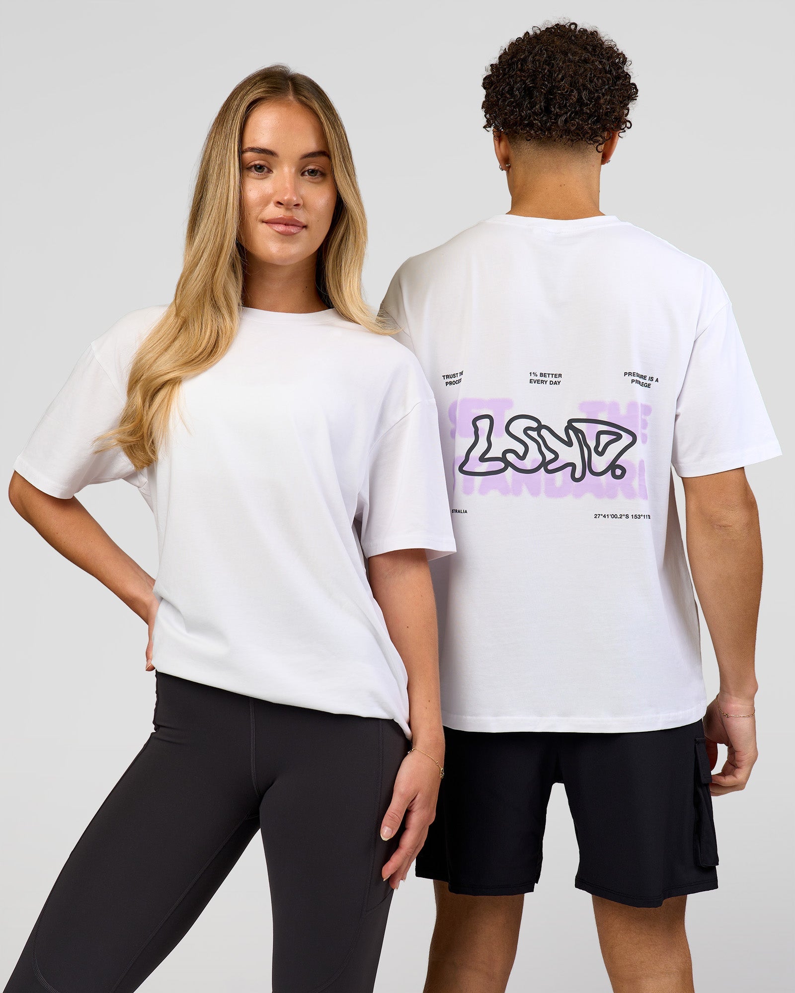 Duo wearing Benchmark FLXCotton Oversized Tee - White-Pale Lilac | Model:Issy | Size:XS | Model:Leandro | Size:M