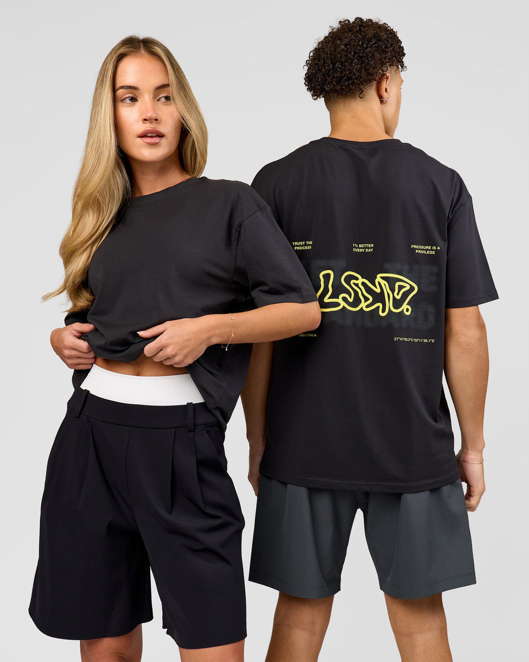 Duo wearing Benchmark FLXCotton Oversized Tee - Onyx-Yellow Fizz | Model:Issy | Size:XS | Model:Leandro | Size:M - view 1