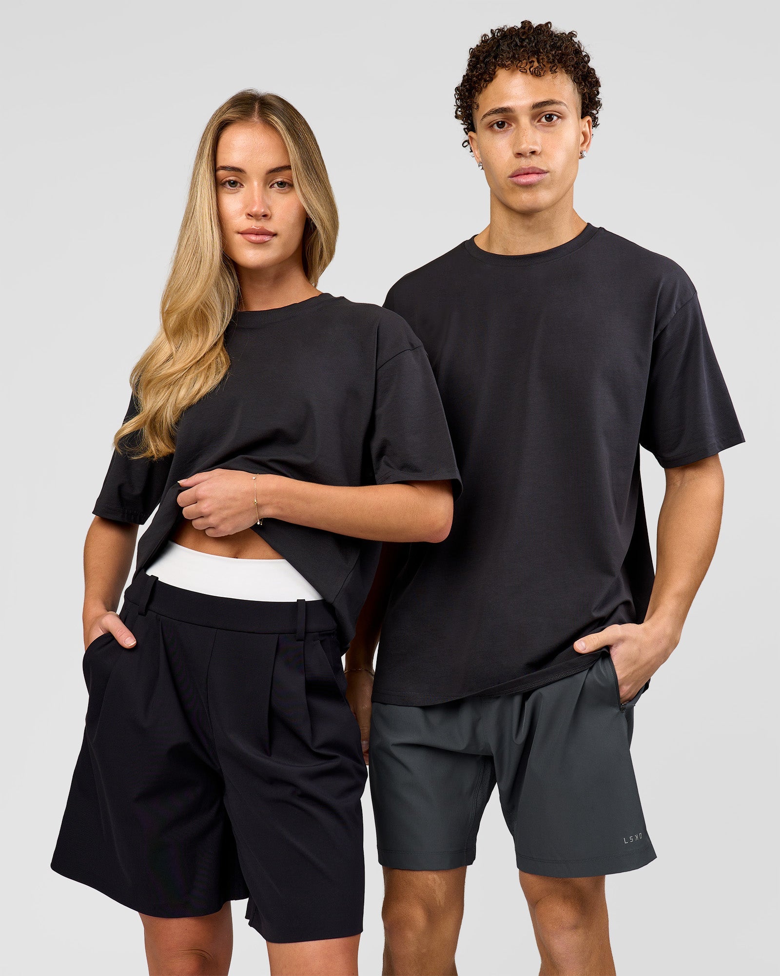 Duo wearing Benchmark FLXCotton Oversized Tee - Onyx-Yellow Fizz | Model:Issy | Size:XS | Model:Leandro | Size:M