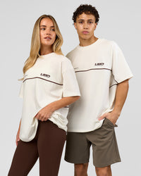 Duo wearing Inline Heavyweight FLXCotton Oversized Tee - Off White-Hot Chocolate | Model:Issy | Size:XS | Model:Leandro | Size:M | Thumbnail Index: 1
