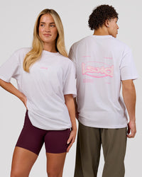 Duo wearing Magma FLXCotton Oversize Tee  - White-Pink Rose | Model:Issy | Size:XS | Model:Leandro | Size:M | Thumbnail Index: 0