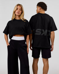 Duo wearing Shadow Mark Heavyweight Oversized Tee - Black-Onyx | Model:Issy | Size:XS | Model:Leandro | Size:M | Thumbnail Index: 0