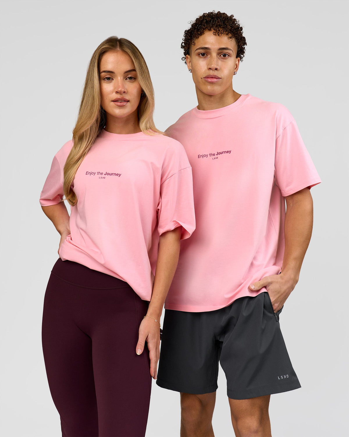 Duo wearing VS1 Enjoy The Journey FLXCotton Oversize Tee - Pink Rose | Model:Issy | Size:XS | Model:Leandro | Size:M