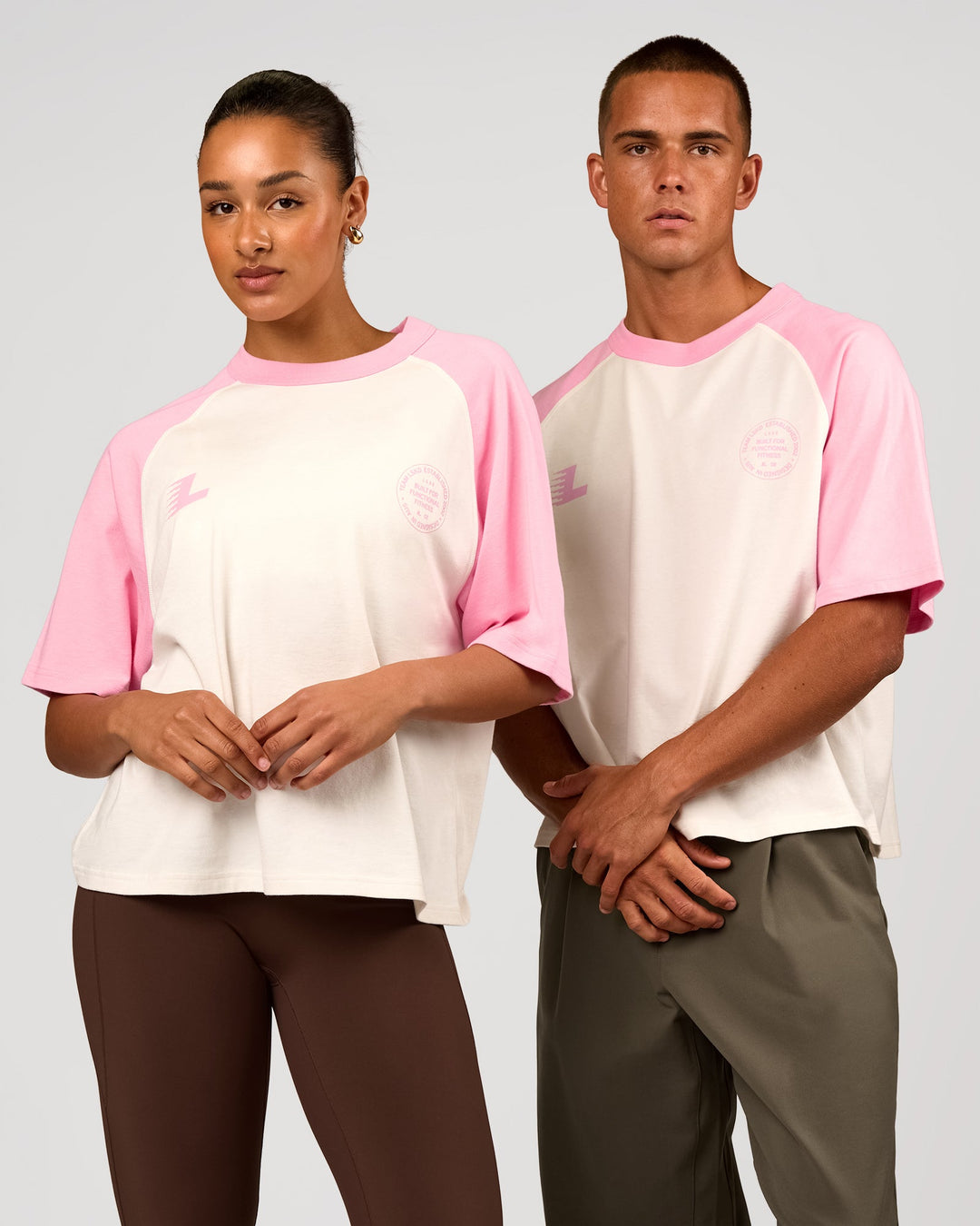 Duo wearing Victory Heavyweight Boxed Raglan Tee - Off White-Pink Rose | Model:Rosie | Size:XS | Model:Albert | Size:M - view 1