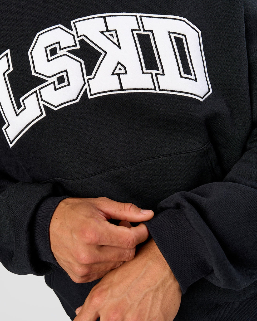 Man wearing Varsity Boxy Hoodie - Caviar-White | Model:Albert | Size:L