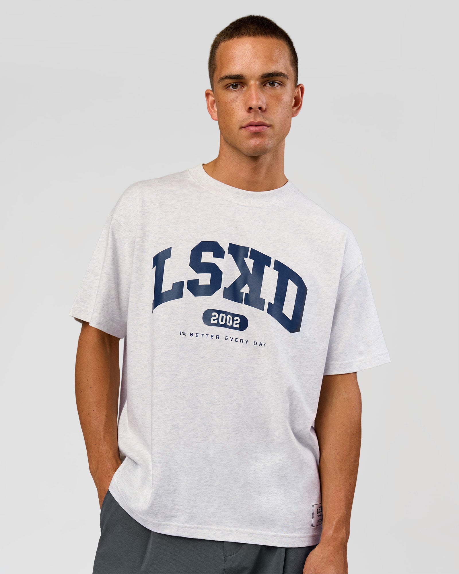 Man wearing Varsity EST Heavyweight Oversized Tee  - Silver Marl-Future Navy | Model:Albert | Size:L