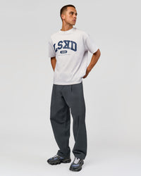 Man wearing Varsity EST Heavyweight Oversized Tee  - Silver Marl-Future Navy | Model:Albert | Size:L