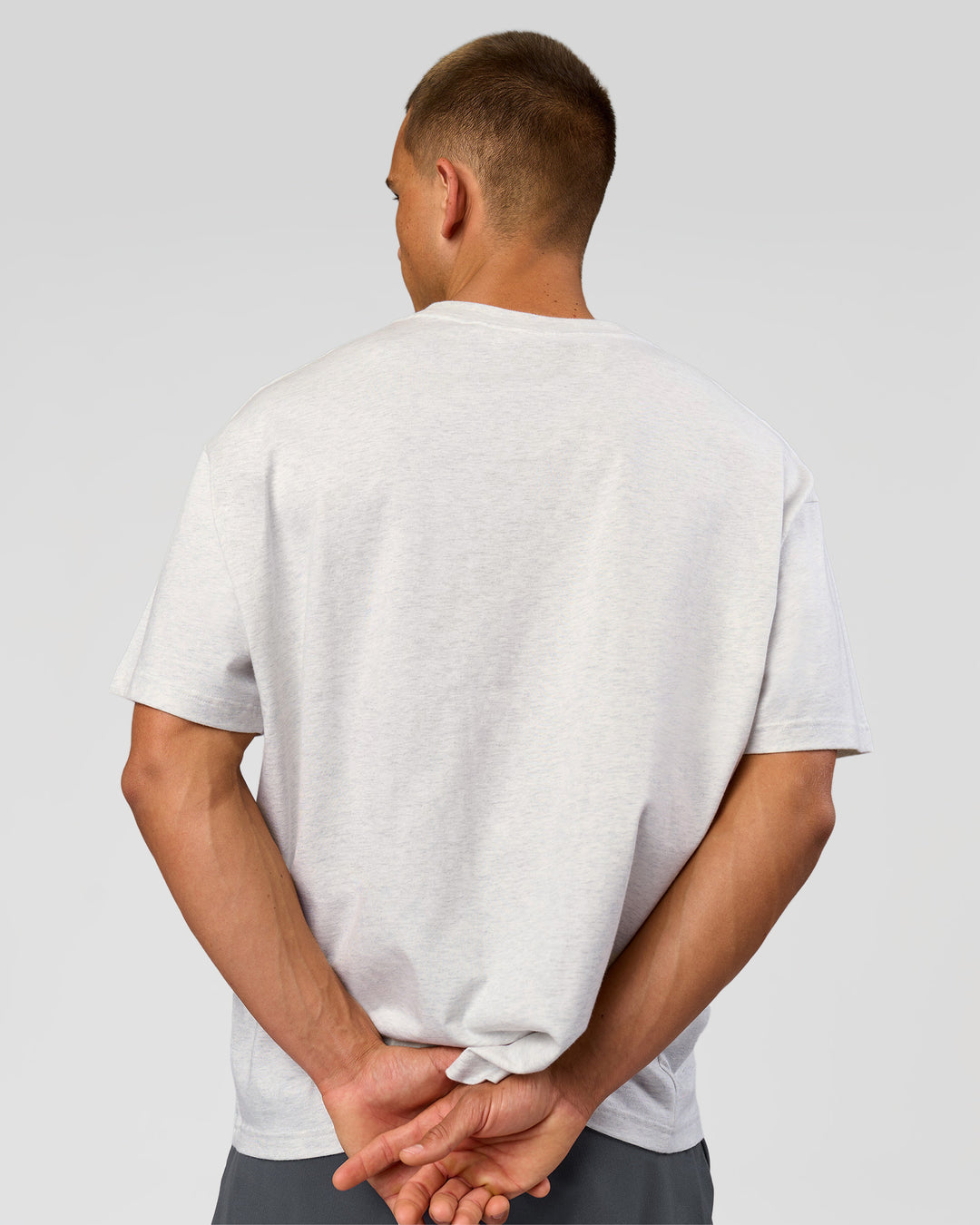 Man wearing Varsity EST Heavyweight Oversized Tee  - Silver Marl-Future Navy | Model:Albert | Size:L