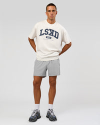 Man wearing Varsity EST Heavyweight Oversized Tee  - Off White-Future Navy | Model:Albert | Size:L