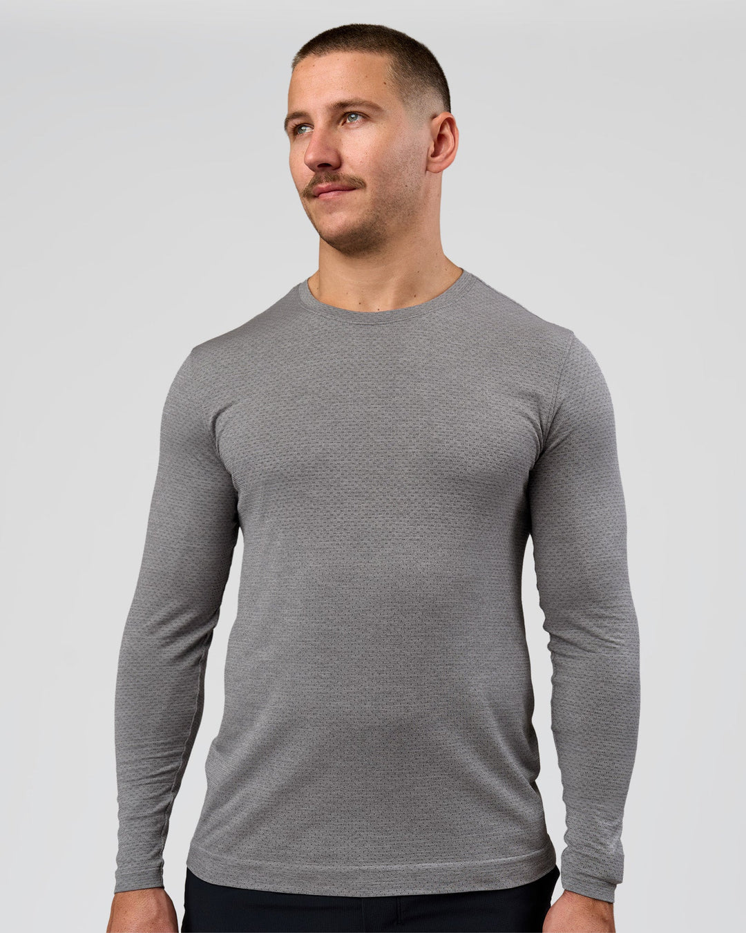 Man wearing AeroFLX+ Seamless Long Sleeve Tee (Set in Sleeve) - Dark Storm/Alloy | Model:Jaiden | Size:L - view 13
