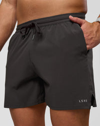 Man wearing Pace 5" Lined Running Short - Black-Onyx | Model:Jaiden | Size:L