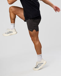 Man wearing Pace 5" Lined Running Short - Black-Onyx | Model:Jaiden | Size:L