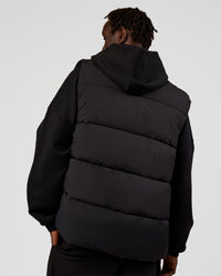 Man wearing Base Puffer Vest - Black | Model:Okello | Size:L | Thumbnail Index: 4